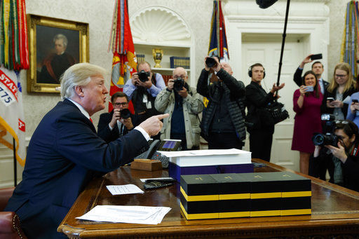 Trump signs stopgap spending bill into law to avert shutdown