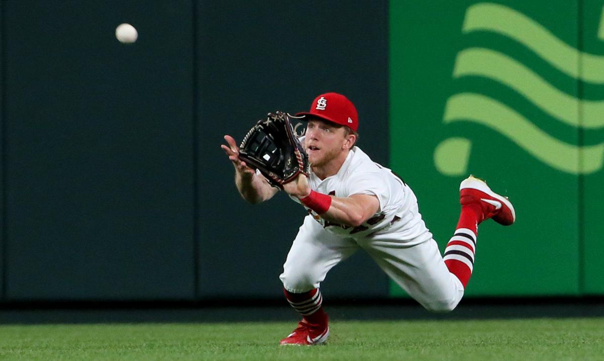 St. Louis Cardinals Harrison Bader makes a throw to first base in in