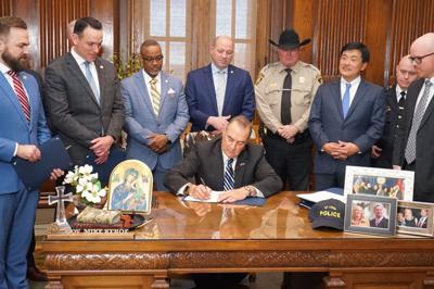 Mike Kehoe signs police takeover bill