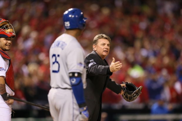 Andy Van Slyke of the St. Louis Cardinals talks to the umpire in
