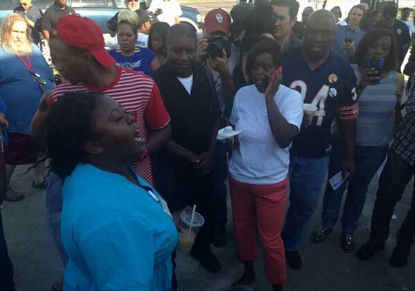 Woman reacts to news conference naming Ferguson officer