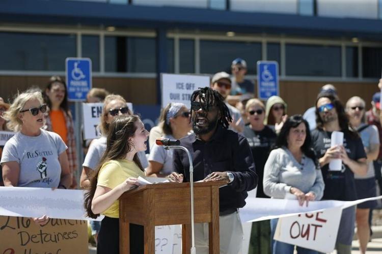 Ela Stark, left, and Ross Neba lead a chant during an Immigrant Justice Collaborative news conference outside of the Greene County Jail on Saturday, April 25 , 2026.