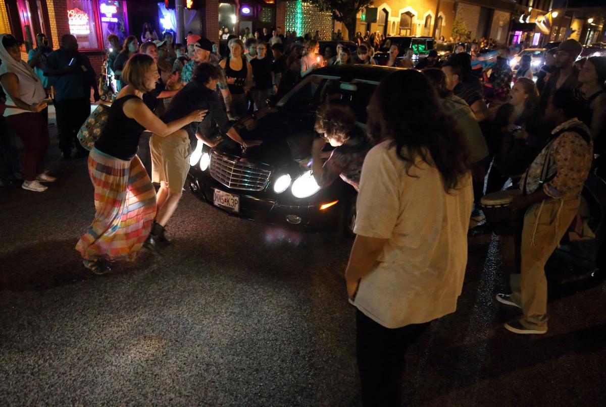 Car drives through protesters in St. Louis