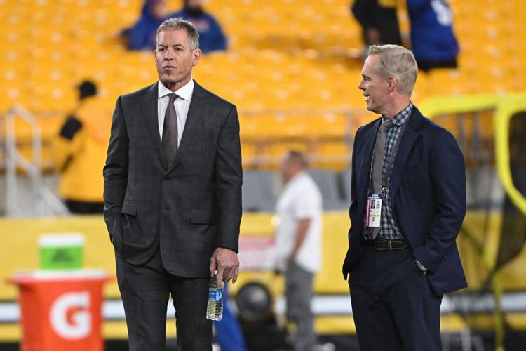 Hall of Fame quarterback Troy Aikman stands with his Monday Night Football broadcast partner Joe Buck before a game between the Pittsburgh Steelers and New York Giants on Oct. 24, 2024, at Acrisure Stadium in Pittsburgh.