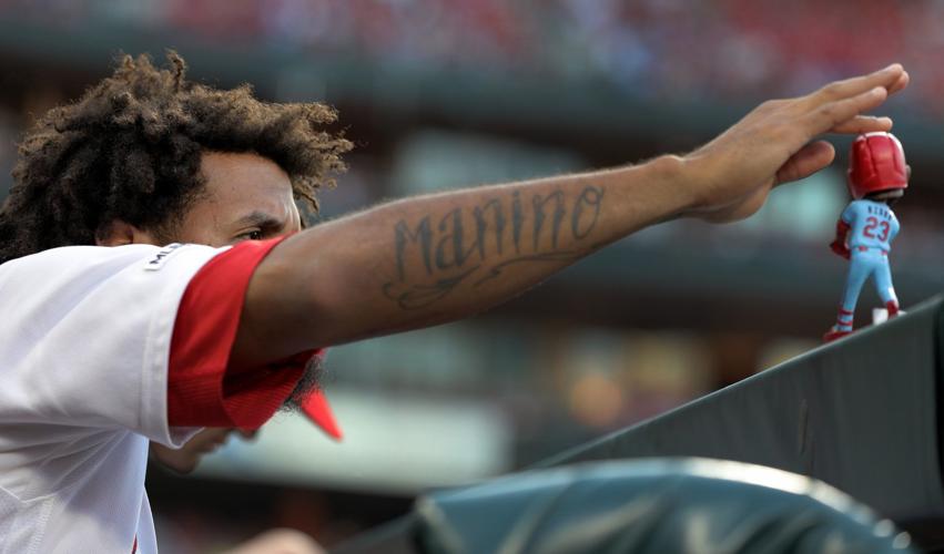 A tattoo is seen on the arm of St. Louis Cardinals' Tyler O'Neill as he  watches from the dugout during the sixth inning of a baseball game against  the San Diego Padres