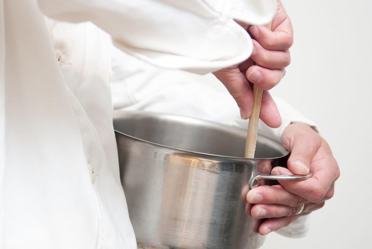 chef preparing food cooking with a pan
