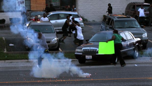 Protesters scatter as officers fire tear gas