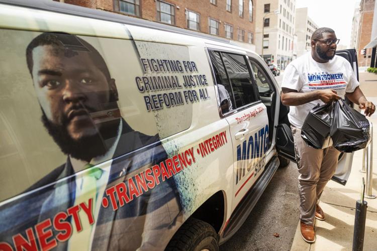 Alfred Montgomery collects campaign signs after upsetting 51 Sheriff Vernon Betts