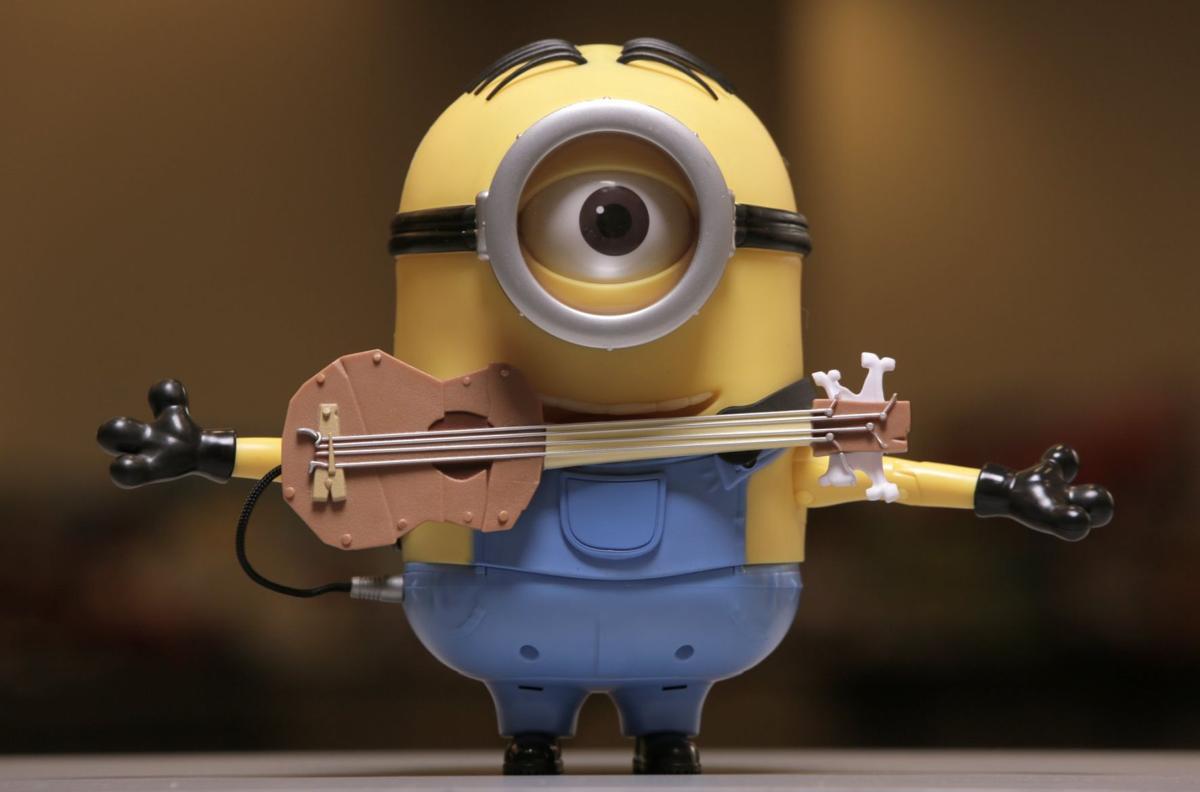 minion stuart interacts with guitar
