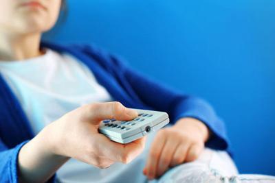 Teenager with remote control