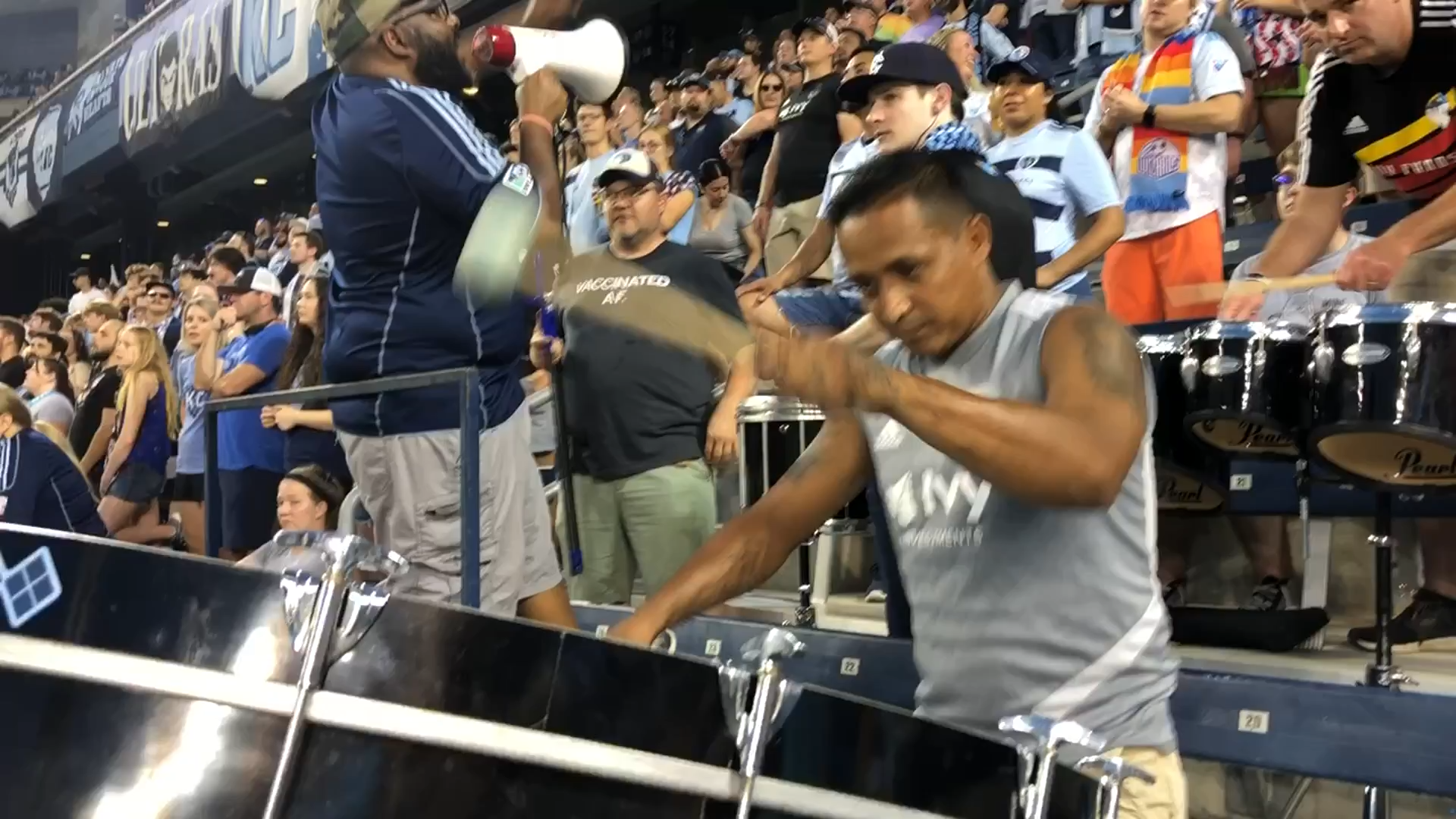 A fan holds up a scarf towards the Sporting Kansas City players