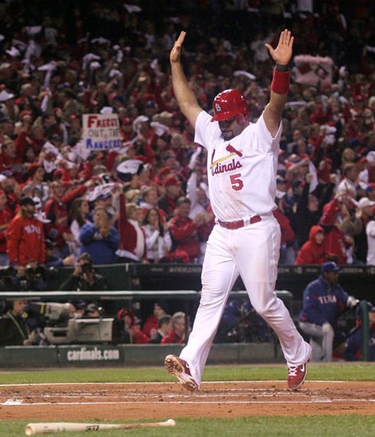 St. Louis Cardinals Lance Berkman embraces Albert Pujols after the  Cardinals won the 2011 World Series in St. Louis on October 28, 2011. The  Cardinals defeated the Texas Rangers 6-2 winning game