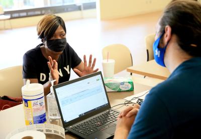 People line up to apply for emergency rental assistance at city sponsored event