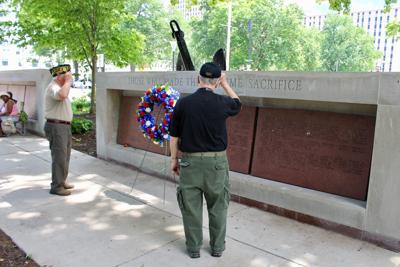 Two Vietnam War veterans pay tribute to those recognized on the Vietnam War Memorial in the Court of Honor at Soldiers Memorial Military Museum.