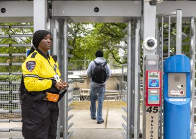 Security guards scan in passengers due to malfunctioning ticket validation at Metro stations