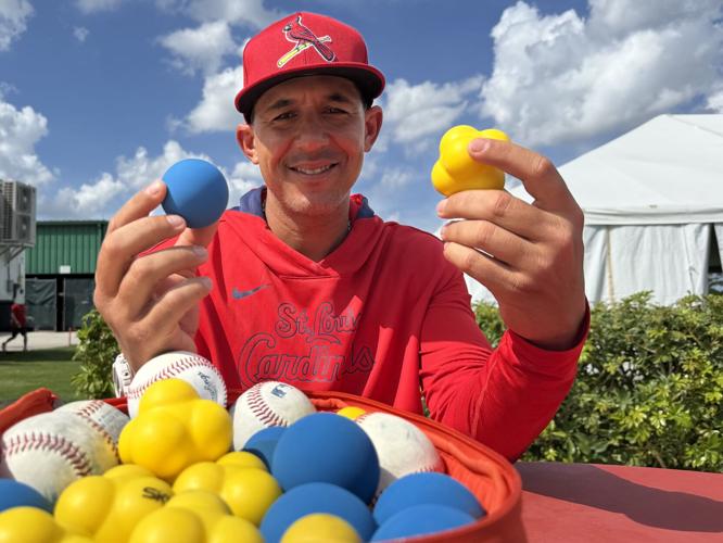 Cardinals coach and former outfielder Jon Jay shows the training balls in his 'bag of tricks'