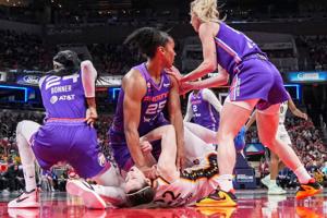 Phoenix Mercury forward Alyssa Thomas (25) scrambles to get up over Indiana Fever guard Caitlin Clark (22) on Wednesday, June