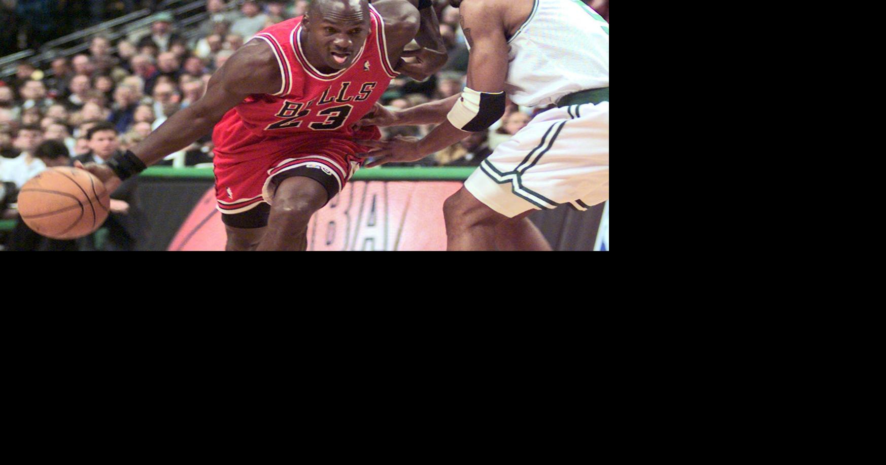 Jud Buechler and Michael Jordan of the Chicago Bulls high five