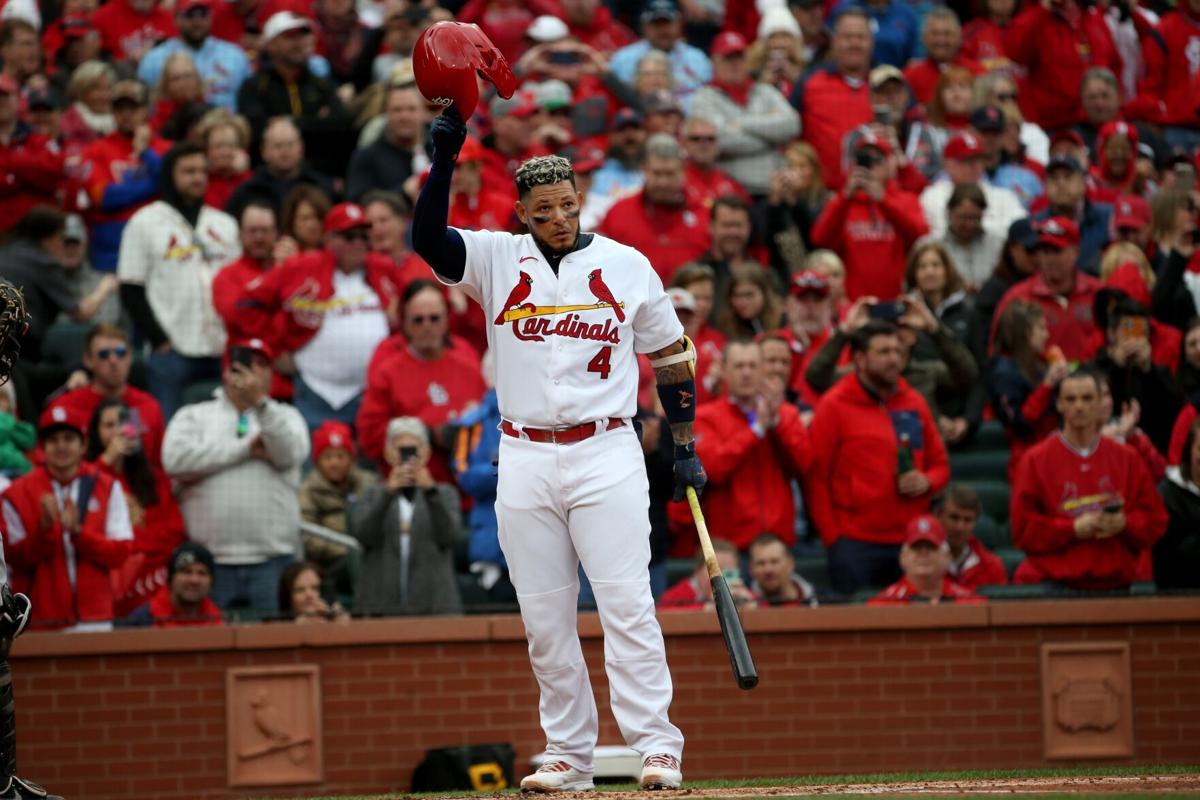 Former St. Louis Cardinals slugger Mark McGwire waves to fans as he is  driven around the track before a game against the Pittsburgh Pirates on  Opening Day in St. Louis on Thursday