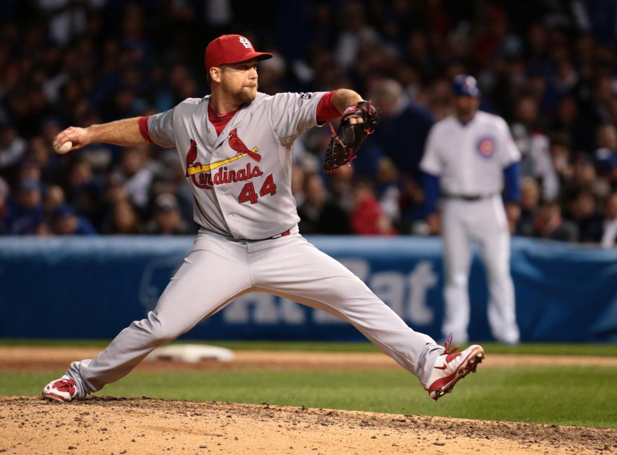 Former St. Louis Cardinals pitcher Al Hrabosky (L) presents Cards