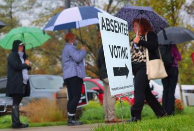 Voters report to polls under light rain