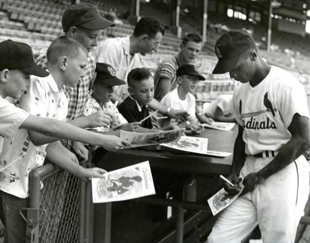 Curt Flood signs autographs