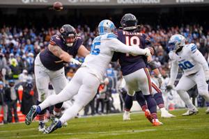 Chicago Bears quarterback Caleb Williams (18) attempts a last second pass as Detroit Lions defensive end Pat O'Connor (95) almost sacks him at Soldier Field during a game at Soldier Field in Chicago, Ill., on Sunday, Dec. 22, 2024. The Lions defeated
