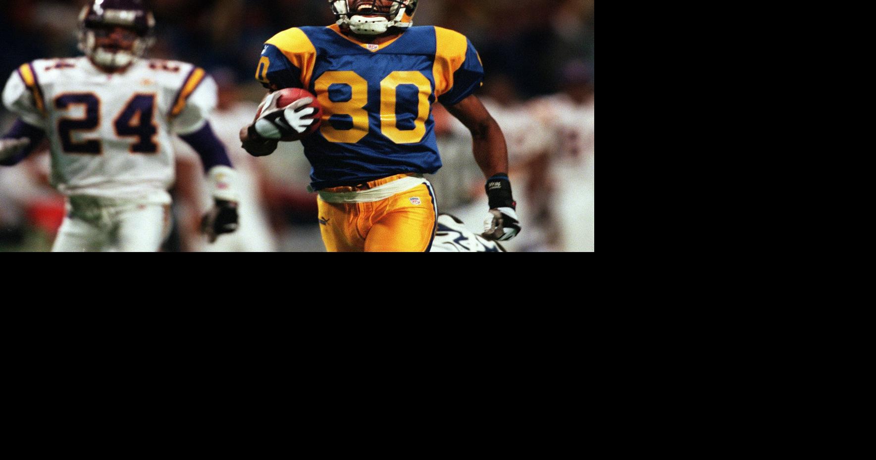 Former St. Louis Rams Isaac Bruce holds the Super Bowl trophy