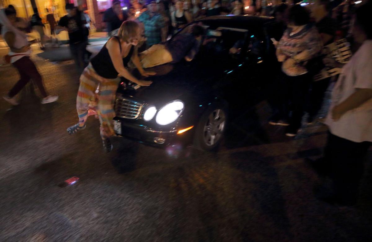 Car drives through protesters in St. Louis