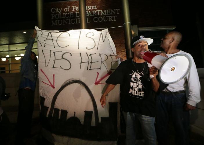 More than 150 demonstrators protest in front of Ferguson Police Station