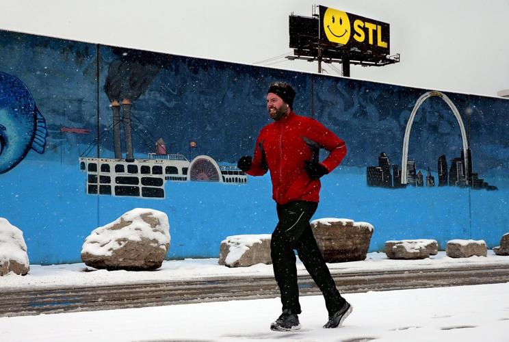 Floodwall mural tagged with graffiti