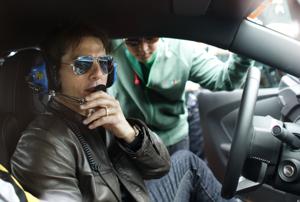 Actor Tom Cruise prepares before driving the pace car to start the Daytona 500 NASCAR Sprint Cup Series race at the Daytona International Speedway in Daytona Beach