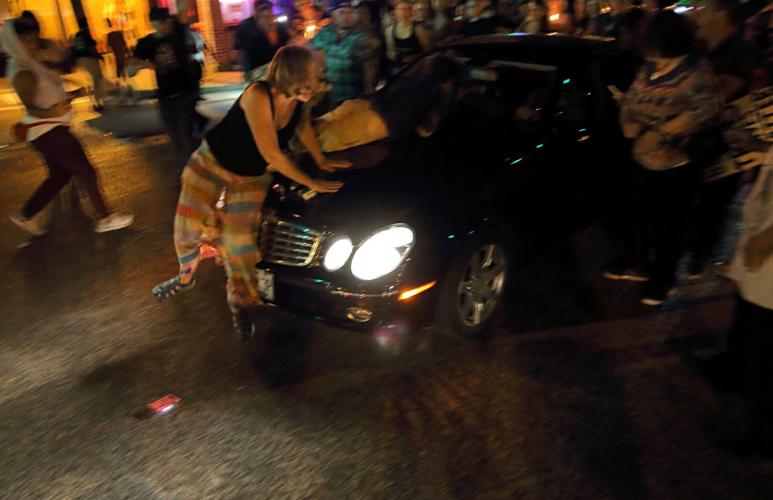 Car drives through protesters in St. Louis