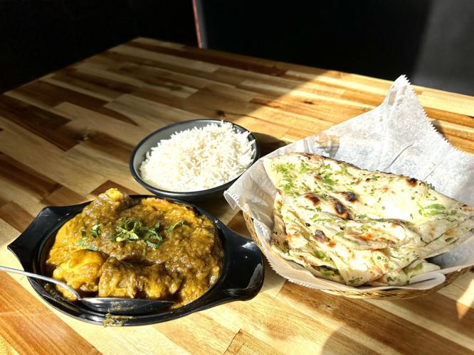 Ian Froeb’s St. Louis musteats a giant pork sandwich, a Cheetos