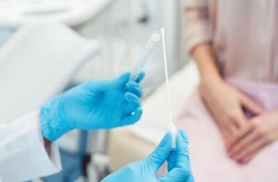 Gynecologist testing vaginal swab for STD
