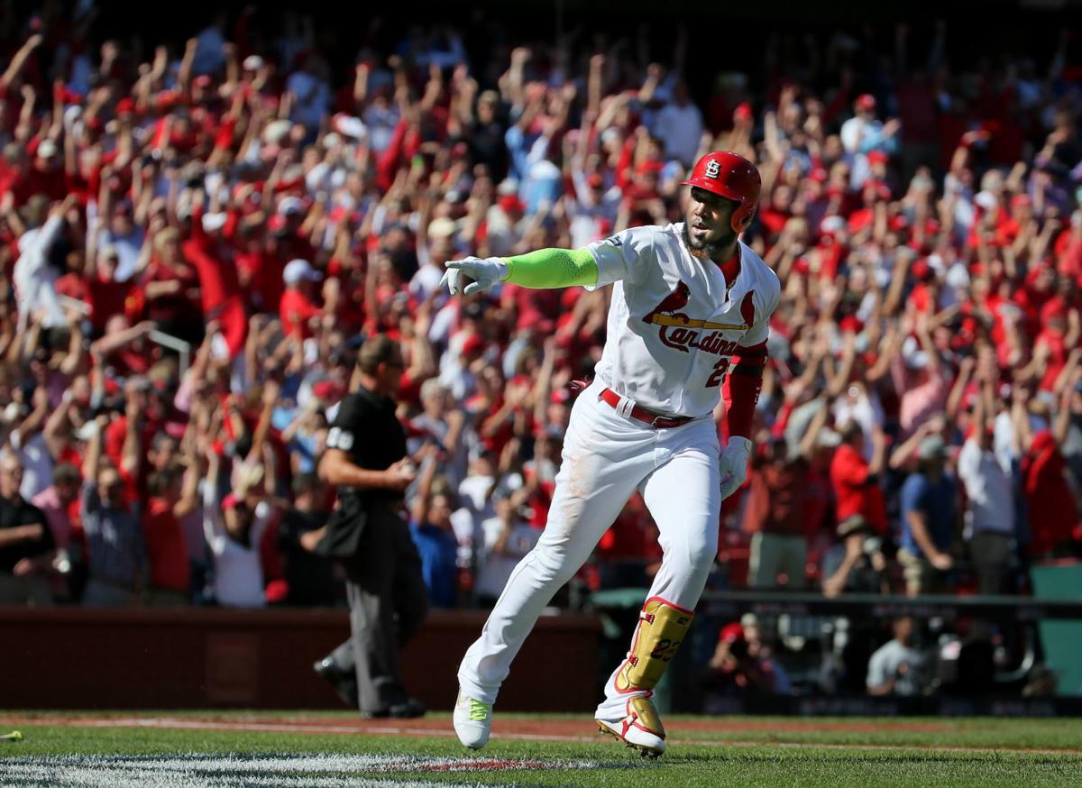 St. Louis Cardinals' Yadier Molina performs throat-slashing gesture after  game-winner