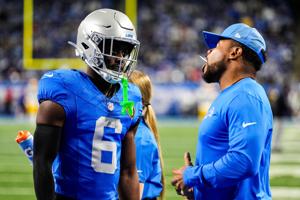 Detroit Lions cornerback Terrion Arnold (6) talks to running backs coach Tashard Rice at warmup ahead of the Green Bay Packers game at Ford Field in Detroit on Thursday, Nov. 27, 2025.