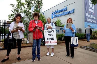 Anti-abortion activists hold weekly prayer vigil