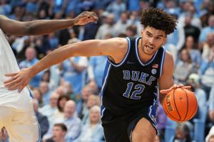 Feb 7, 2026; Chapel Hill, North Carolina, USA; Duke Blue Devils forward Cameron Boozer (12) with the ball as North Carolina Tar Heels forward Caleb Wilson (8) defends in the first half at Dean E. Smith Center. Mandatory Credit: Bob Donnan-Imagn Image
