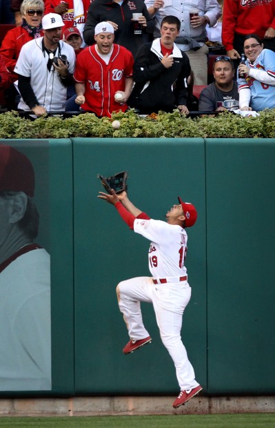 Jon Jay of the St. Louis Cardinals, left, celebrates with teammate Daniel  Descalso after scoring in the seventh inning against the Washington  Nationals in Game 3 of their National League Division Series