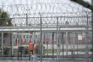 Immigration detainees are moved in secure groups between buildings and recreation fields at the detention facility in Miami.