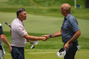 Padraig Harrington and Stewart Cink shake hands following the third round of the U.S. Senior Open at Scioto Country Club in