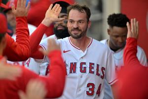 Jun 8, 2026; Anaheim, California, USA; Los Angeles Angels left fielder Trey Mancini (34) is greeted in the dugout after scoring a run in the second inning against the Houston Astros at Angel Stadium. Mandatory Credit: Jayne Kamin-Oncea-Imagn Images