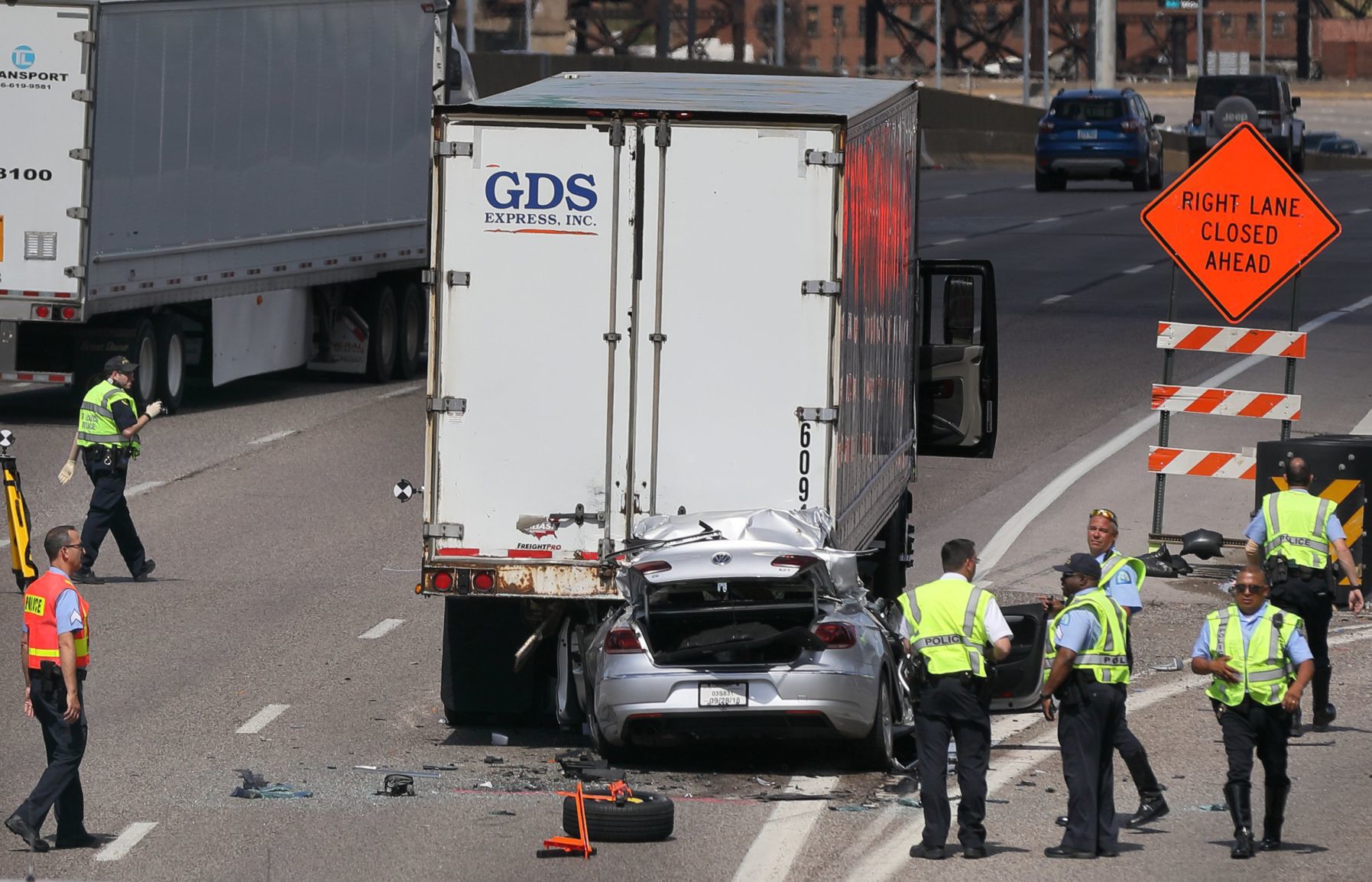 truck backs into car