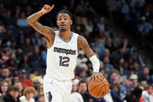 Grizzlies' Ja Morant (12) gestures to his teammates while he brings the ball up the court during the game between the Milwaukee Bucks and Memphis Grizzlies at FedExForum in Memphis, Tenn., on December 26, 2025.