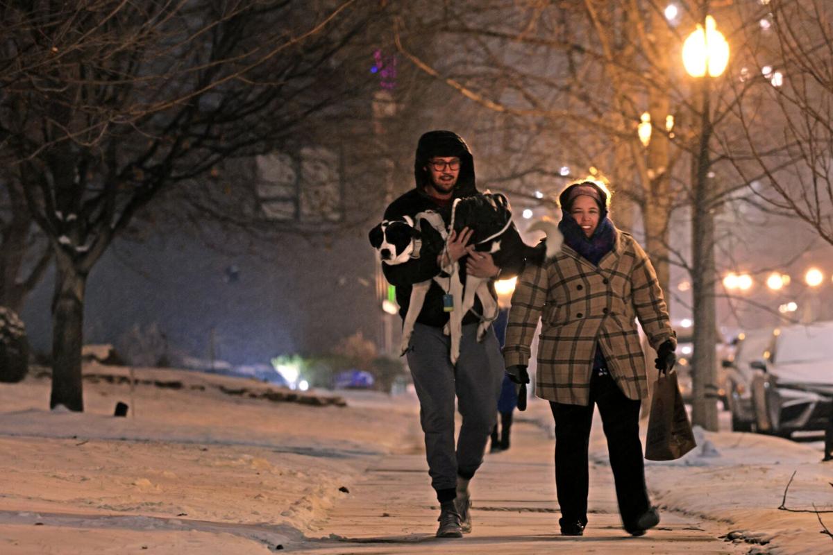 Light snow blankets streets as temperatures drop