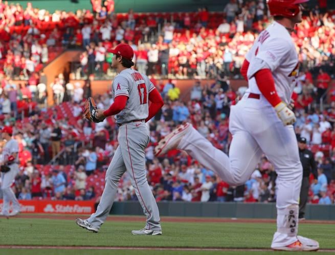 Los Angeles Angels' Jake Lamb is congratulated by third base coach