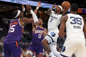 Jan 7, 2026; Memphis, Tennessee, USA; Memphis Grizzlies forward Kentavious Caldwell-Pope (3) drives to the basket as Phoenix Suns forward Ryan Dunn (0) defends during the fourth quarter at FedExForum. Mandatory Credit: Petre Thomas-Imagn Images