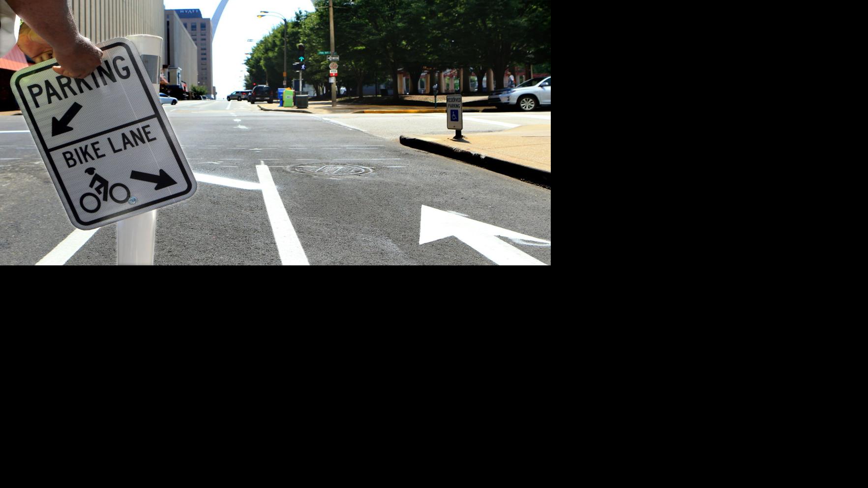 Signs explaining parkingprotected bike lanes going up on Chestnut