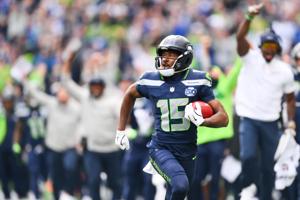 Sep 21, 2025; Seattle, Washington, USA; Seattle Seahawks wide receiver Tory Horton (15) makes a 95 yard punt return for a touchdown during the first quarter against the New Orleans Saints at Lumen Field. Mandatory Credit: Steven Bisig-Imagn Images